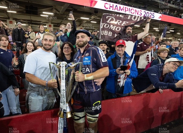 240525 - Northampton Saints v Union Bordeaux-Begles, EPCR Champions Cup Final - Union Bordeaux-Begles players celebrate with the trophy and fans