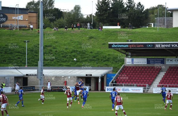 050920 - Northampton Town v Cardiff City - Carabao Cup First Round South - Supporters look on from a bank overlooking the PTS Academy Stadium