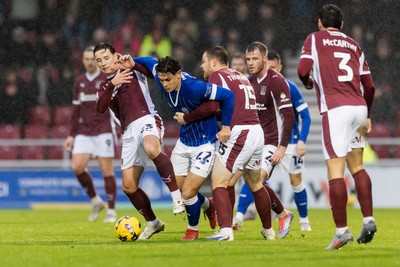 221125 - Northampton Town v Cardiff City - Sky Bet League 1 - Yousef Salech of Cardiff City held by Terry Taylor of Northampton Town and Jordan Thorniley of Northampton Town