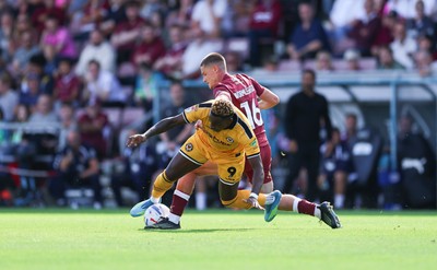 050926 - Northampton Town v Newport County, EFL Sky Bet League 2 - Shaquille Gwengwe of Newport County is challenged by Joe Wormleighton of Northampton Town