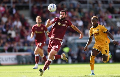 050926 - Northampton Town v Newport County, EFL Sky Bet League 2 - Elliott Moore of Northampton Town clears the ball under pressure from Shaquille Gwengwe of Newport County