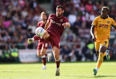 050926 - Northampton Town v Newport County, EFL Sky Bet League 2 - Elliott Moore of Northampton Town clears the ball under pressure from Shaquille Gwengwe of Newport County