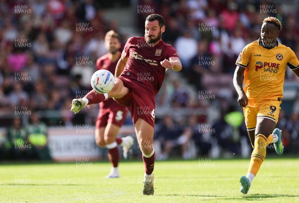 050926 - Northampton Town v Newport County, EFL Sky Bet League 2 - Elliott Moore of Northampton Town clears the ball under pressure from Shaquille Gwengwe of Newport County