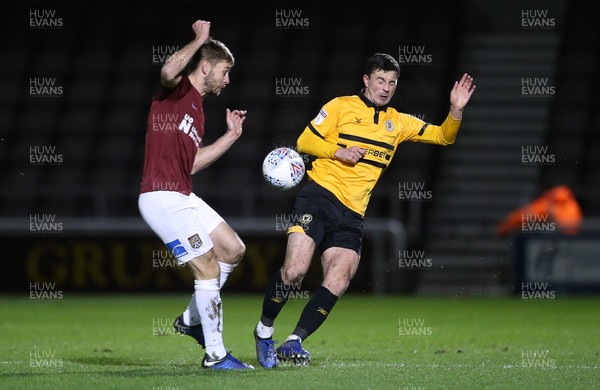 120319 - Northampton Town v Newport County - SkyBet League Two - Padraig Amond of Newport County is tackled by Sam Foley of Northampton