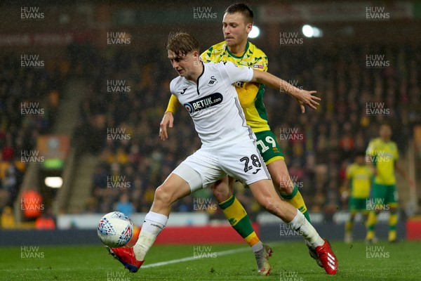 080319 - Norwich City v Swansea City - Sky Bet Championship -  George Byers of Swansea City shields the ball from Tom Trybull of Norwich City 