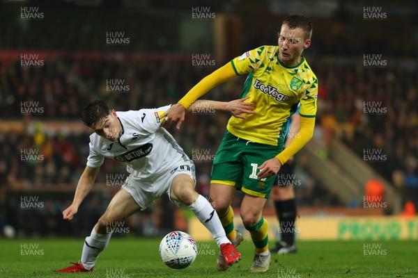 080319 - Norwich City v Swansea City - Sky Bet Championship -  Daniel James of Swansea City and Tom Trybull of Norwich City battle for possession 