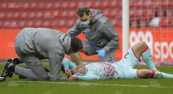 291120 - Nottingham Forest v Swansea City - Sky Bet Championship - Connor Roberts of Swansea lies injured with attending medics after his goal in the 1st half