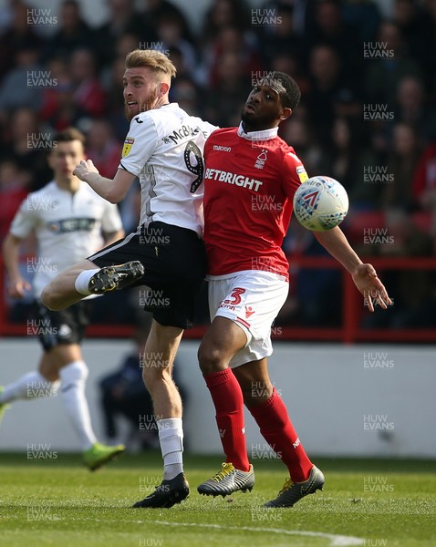 300319 - Nottingham Forest v Swansea City - SkyBet Championship - Oli McBurnie of Swansea City is challenged by Molla Wague of Nottingham Forest