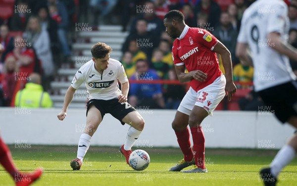300319 - Nottingham Forest v Swansea City - SkyBet Championship - Daniel James of Swansea City is challenged by Molla Wague of Nottingham Forest