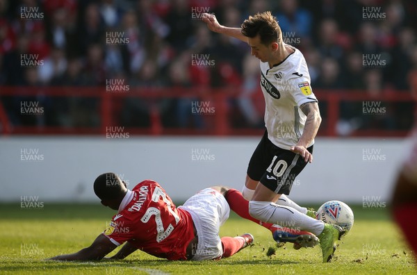 300319 - Nottingham Forest v Swansea City - SkyBet Championship - Bersant Celina of Swansea City is tackled by Tendayi Darikwa of Nottingham Forest