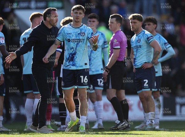 060426 - Notts County v Newport County - Sky Bet League 2 - Team mates and Referee look on as Newport manager Christian Fuchs and James Crole of Newport argue at the end of the match