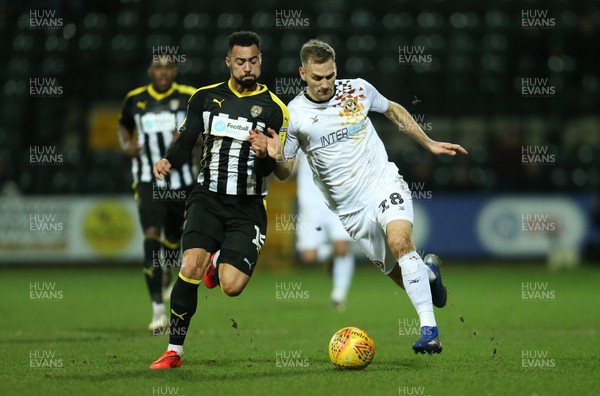 190219 - Notts County v Newport County, Sky Bet League 2 - Mickey Demetriou of Newport County is challenged by Kane Hemmings of Notts County