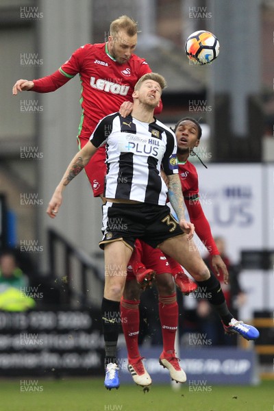 270118 - Notts County v Swansea City, FA Cup Fourth Round - Mike van der Hoorn of Swansea City (left) out jumps Jonathan Stead of Notts County