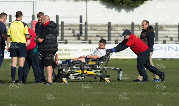 231019 - Neath Port Talbot College v Llandovery College, WRU National Schools and Colleges League - Louis Rees of Llandovery College is stretchered off the pitch at The Gnoll, Neath, after a nail pierced his boot and injured his foot as he ran out for the start of the match The match was moved to Llandarcy on player safety grounds