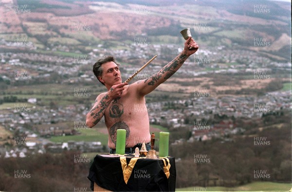 160395 - Obediah Cann performing an Earth-Air ceremony with wand and chalice at his alter near Aberdare, South Wales