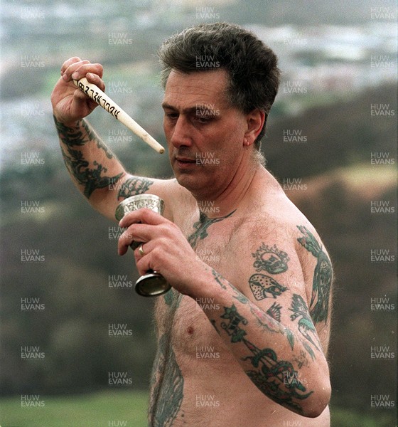 160395 - Obediah Cann performing an Earth-Air ceremony with wand and chalice at his alter near Aberdare, South Wales