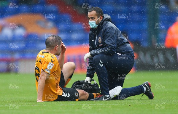 070821 - Oldham Athletic v Newport County, EFL Sky Bet League 2 - Matty Dolan of Newport County receives treatment for injury before being replaced