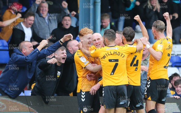 070821 - Oldham Athletic v Newport County, EFL Sky Bet League 2 - Kevin Ellison of Newport County, centre, celebrates with players and fans after scoring the winning goal