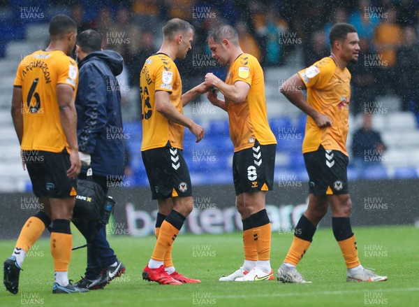 070821 - Oldham Athletic v Newport County, EFL Sky Bet League 2 - Matty Dolan of Newport County hands the captain's armband to Mickey Demetriou of Newport County as he leaves the pitch with an injury