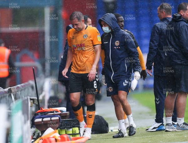070821 - Oldham Athletic v Newport County, EFL Sky Bet League 2 - Matty Dolan of Newport County leaves the pitch with an injury