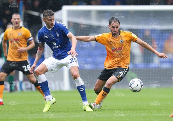 070821 - Oldham Athletic v Newport County, EFL Sky Bet League 2 - Ed Upson of Newport County takes on Jacob Blyth of Oldham Athletic and Davis Keillor-Dunn of Oldham Athletic
