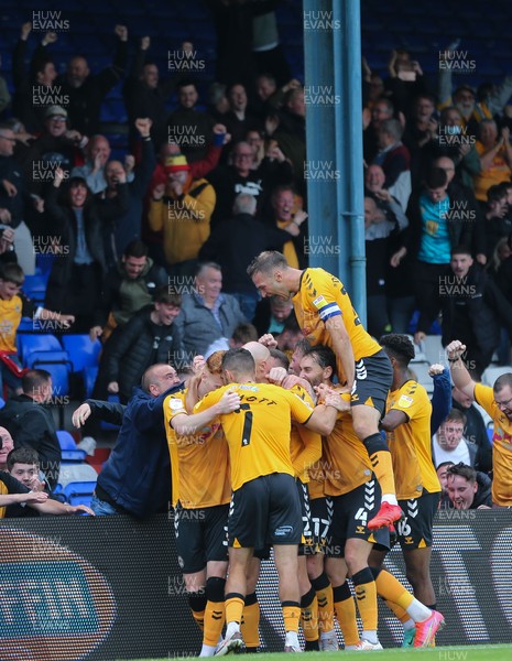 070821 - Oldham Athletic v Newport County, EFL Sky Bet League 2 - Kevin Ellison of Newport County is mobbed by team mates and fans as he celebrates after scoring goal