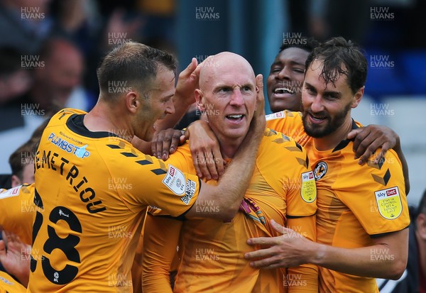 070821 - Oldham Athletic v Newport County, EFL Sky Bet League 2 - Kevin Ellison of Newport County is congratulated by Mickey Demetriou of Newport County and Ed Upson of Newport County after scoring goal