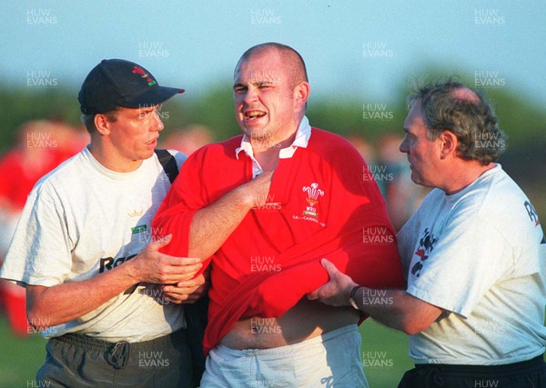 15.07.97 Wales Tour to America and Canada... Ontario v Wales. Aled Griffiths who arrived as a replacement for Christian Loader is led off the field by Howell Griffiths(lt) and Bob Leyshon(rt) with a dislocated shoulder at Mohawk Sports Park, Hamilton. 