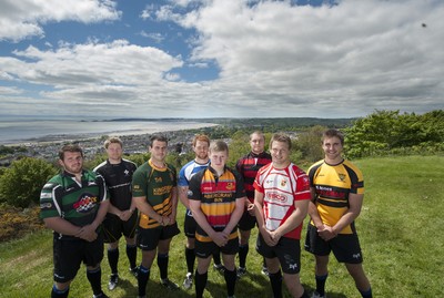 220513 - Ospreys - Pictured with Swansea Bay in the background are Opsreys players LtR: Ryan Bevington in Porthcawl kit, Jonathan Spratt in Neath Athletic kit, Scott Baldwin in Bridgend Athletic kit, Dan Baker in Astradgynlais kit, Dafydd Howells in Abercrave kit, James King in Mold kit, Dan Biggar in Gorseinon kit and Ashley Beck in Skewen kit