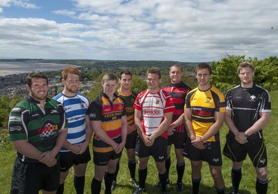 220513 - Ospreys - Pictured with Swansea Bay in the background are Opsreys players LtR: Ryan Bevington in Porthcawl kit, Dan Baker in Astradgynlais kit, Dafydd Howells in Abercrave kit, Scott Baldwin in Bridgend Athletic kit, Dan Biggar in Gorseinon kit, James King in Mold kit, Ashley Beck in Skewen kit and Jonathan Spratt in Neath Athletic kit