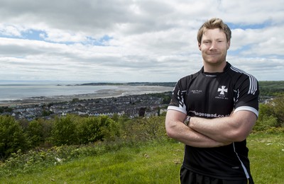 220513 - Ospreys - Pictured with Swansea Bay in the background is Jonathan Spratt in Neath Athletic RFC kit