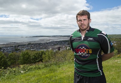 220513 - Ospreys - Pictured with Swansea Bay in the background is Ryan Bevington in Porthcawl kit