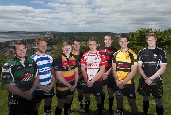 220513 - Ospreys - Pictured with Swansea Bay in the background are Opsreys players LtR: Ryan Bevington in Porthcawl kit, Dan Baker in Astradgynlais kit, Dafydd Howells in Abercrave kit, Scott Baldwin in Bridgend Athletic kit, Dan Biggar in Gorseinon kit, James King in Mold kit, Ashley Beck in Skewen kit and Jonathan Spratt in Neath Athletic kit