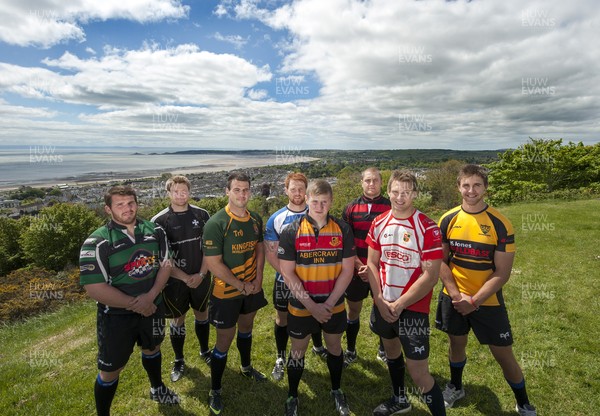 220513 - Ospreys - Pictured with Swansea Bay in the background are Opsreys players LtR: Ryan Bevington in Porthcawl kit, Jonathan Spratt in Neath Athletic kit, Scott Baldwin in Bridgend Athletic kit, Dan Baker in Astradgynlais kit, Dafydd Howells in Abercrave kit, James King in Mold kit, Dan Biggar in Gorseinon kit and Ashley Beck in Skewen kit