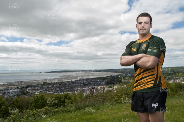 220513 - Ospreys - Pictured with Swansea Bay in the background is Scott Baldwin in Bridgend Athletic RFC kit