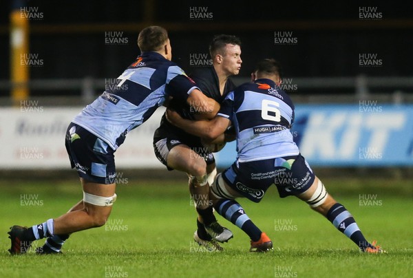 130919 - Ospreys Development v Cardiff Blues A, Celtic Cup - Callum Carson of Ospreys Development is tackled by Aled Ward of Cardiff Blues A and Teddy Williams of Cardiff Blues A