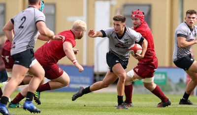 150918 - Ospreys Development v Munster A - Celtic Cup - Dewi Cross of Ospreys is tackled by Jeremy Loughman of Munster