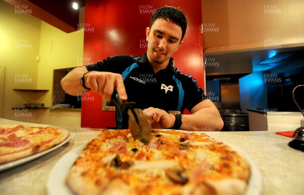 09.01.12 - Ospreys - Kristian Phillips participating in a pizza cook-off challenge at Mamma Mia in Swansea ahead of the Ospreys game against Benetton Treviso on Friday. 