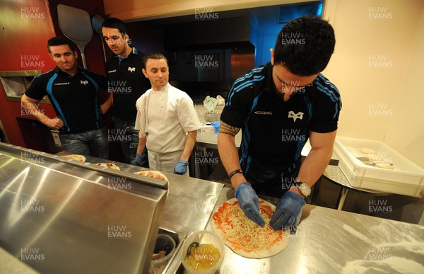 09.01.12 - Ospreys - Kristian Phillips(R), Huw Bennett and Jonathan Thomas participating in a pizza cook-off challenge as chef Victor Baba looks on at Mamma Mia in Swansea ahead of the Ospreys game against Benetton Treviso on Friday. 