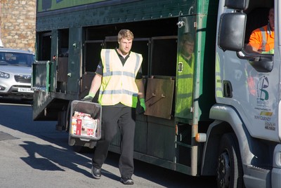 290714 -  Ospreys Jonathan Spratt helps out on the council's household recycling collection in Maesteg 