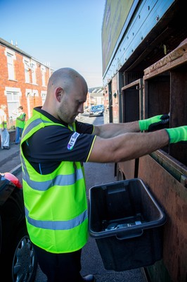 290714 -  Ospreys Richard Fussell helps out on the council's household recycling collection in Maesteg 