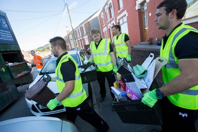 290714 -  Ospreys players take part in the council's household recycling collection in Maesteg