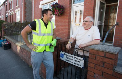 290714 -  Ospreys Joe Bearman helps out on the council's household recycling collection in Maesteg 