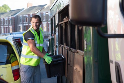 290714 -  Ospreys Joe Bearman helps out on the council's household recycling collection in Maesteg 