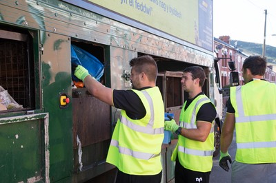 290714 -  Ospreys players take part in the council's household recycling collection in Maesteg