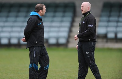 160212 - Ospreys Rugby Training -Ospreys head coach Steve Tandy talks to forwards coach Jonathan Humphreys(L) during training