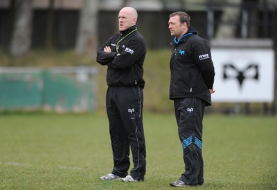 160212 - Ospreys Rugby Training -Ospreys head coach Steve Tandy talks to forwards coach Jonathan Humphreys(R) during training