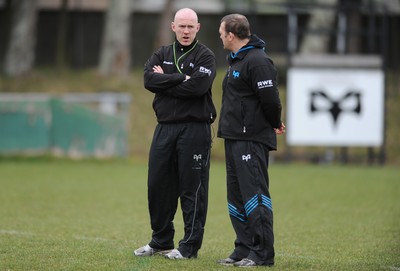 160212 - Ospreys Rugby Training -Ospreys head coach Steve Tandy talks to forwards coach Jonathan Humphreys(R) during training