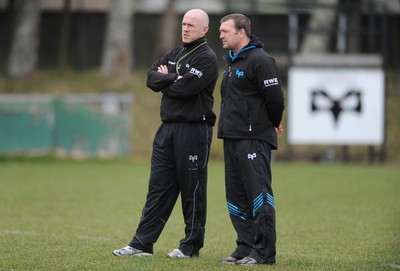 160212 - Ospreys Rugby Training -Ospreys head coach Steve Tandy talks to forwards coach Jonathan Humphreys(R) during training