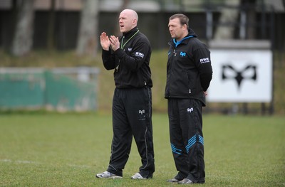 160212 - Ospreys Rugby Training -Ospreys head coach Steve Tandy talks to forwards coach Jonathan Humphreys(R) during training